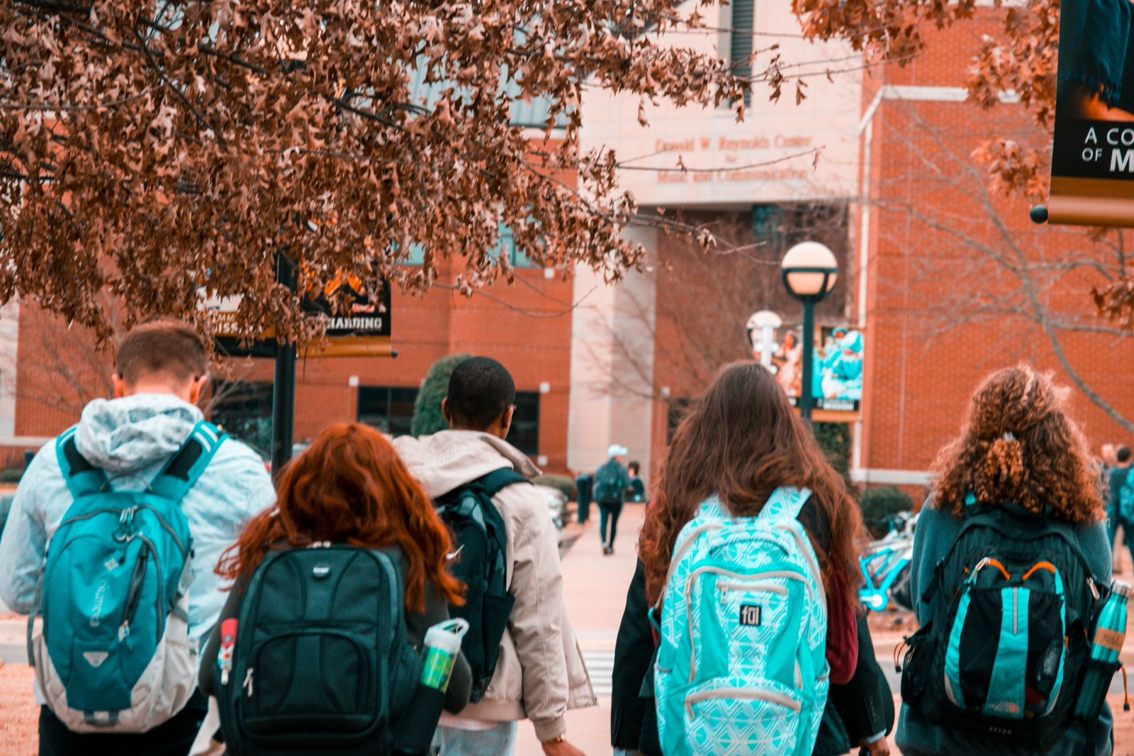 Students with backpacks walking together across a university campus