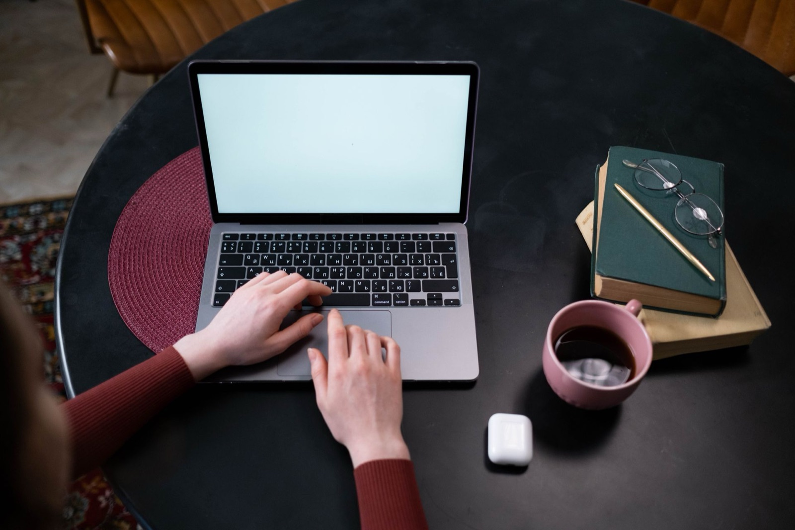 Hands navigating a laptop using the keyboard