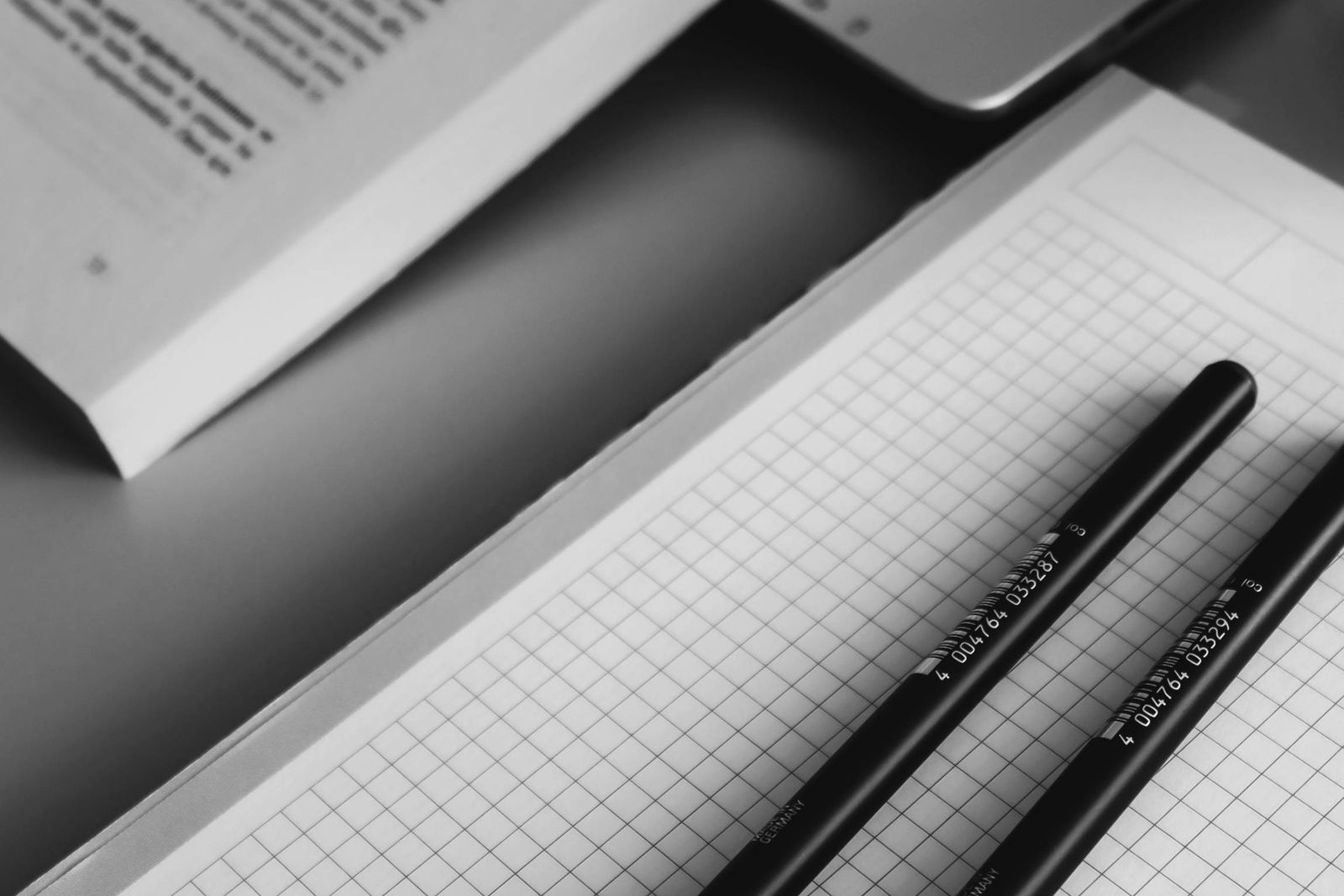 Black and White Study Desk with Open Book and Pens