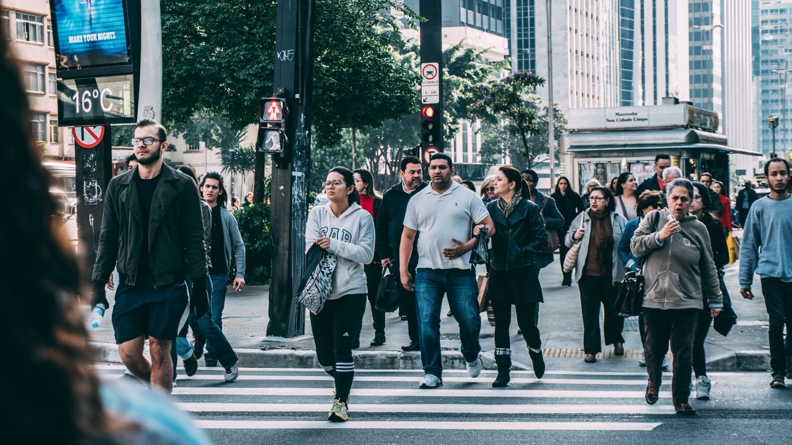Residents crossing a busy city street