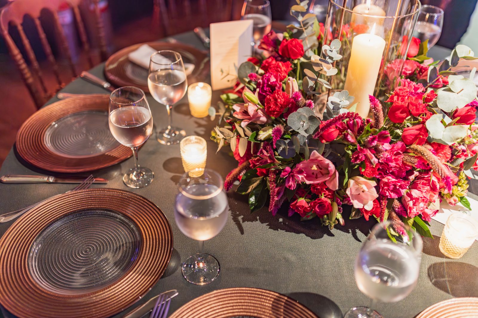 Banquet hall dressed with round tables and centerpieces ahead of a gala dinner