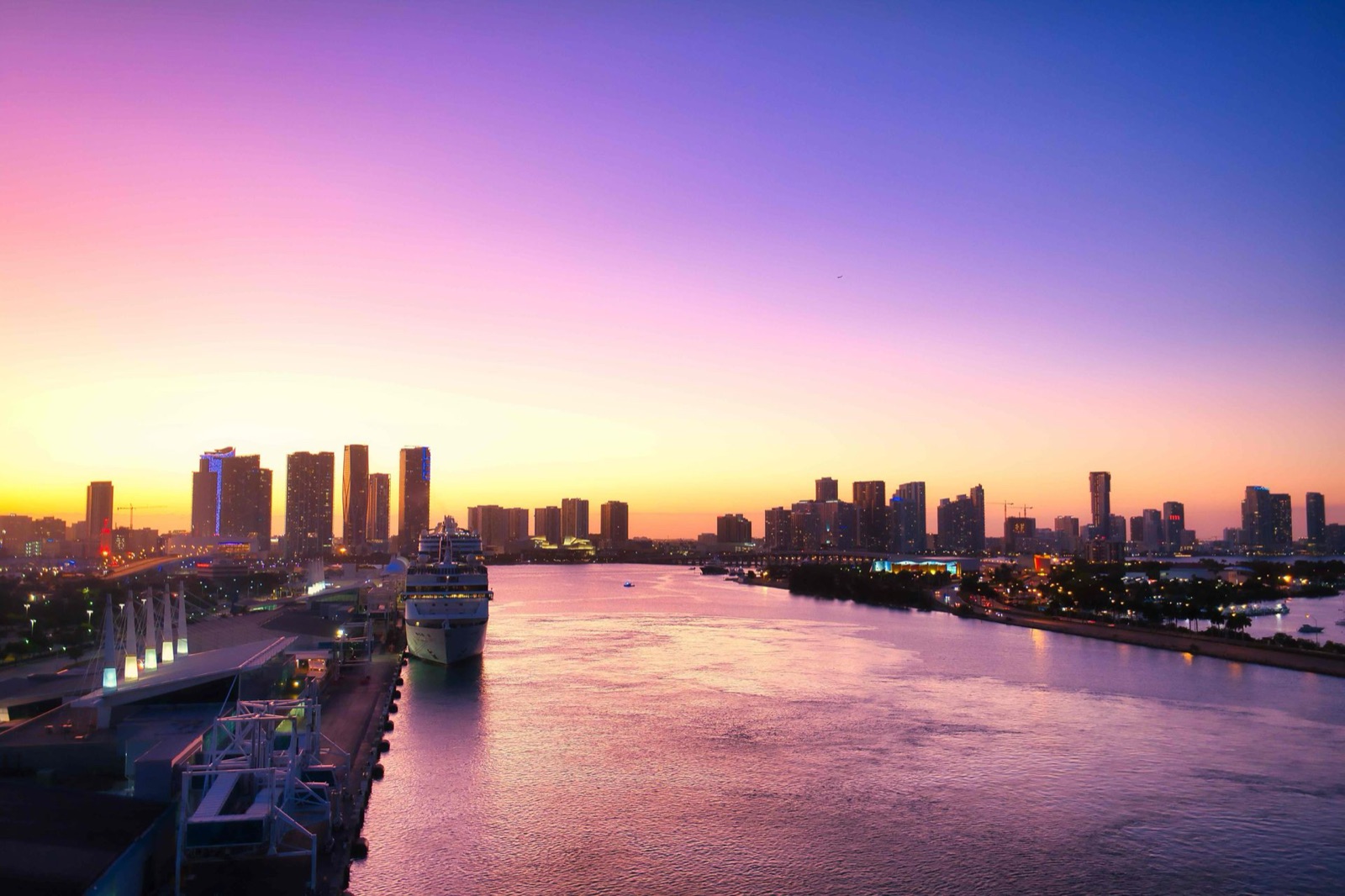 The Miami skyline and port at sunset seen across the water