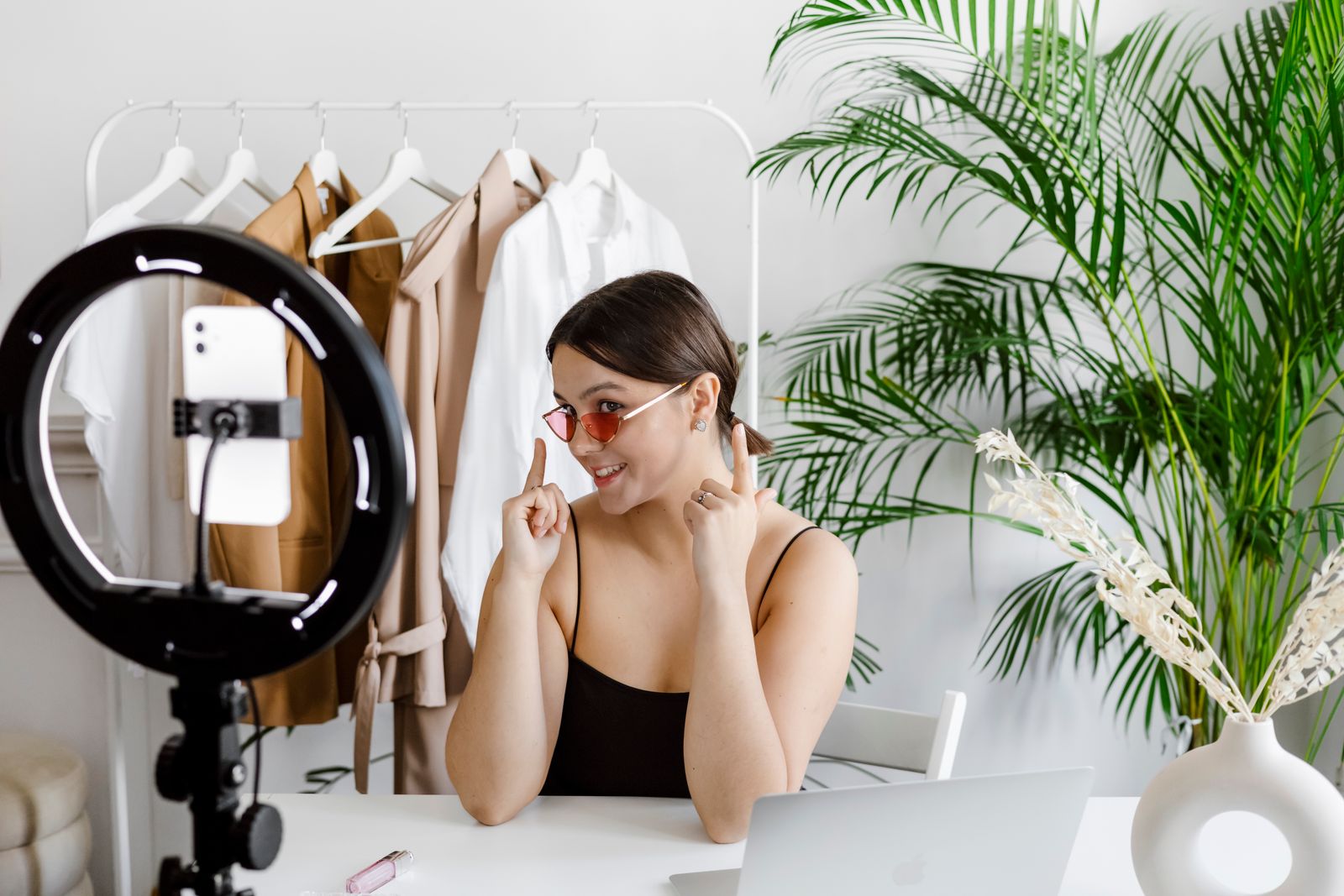 A creator filming a product video on a phone under a ring light
