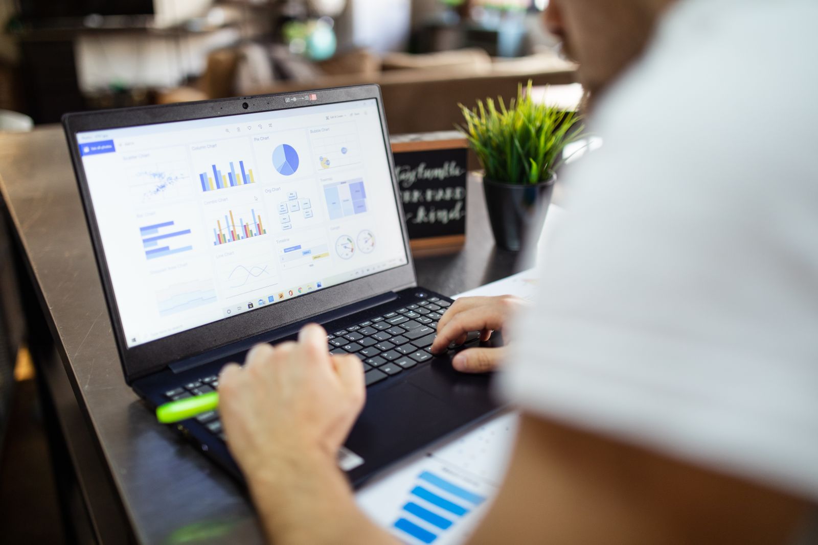 A business owner reviewing performance charts on a laptop