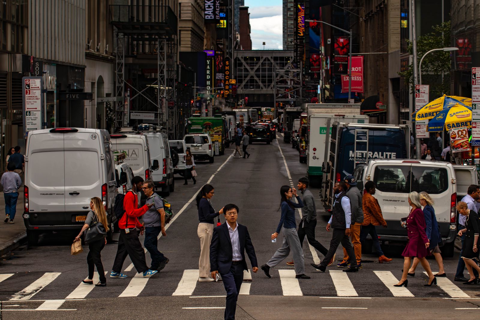 Crowds filling a busy city street, the public a government website has to serve