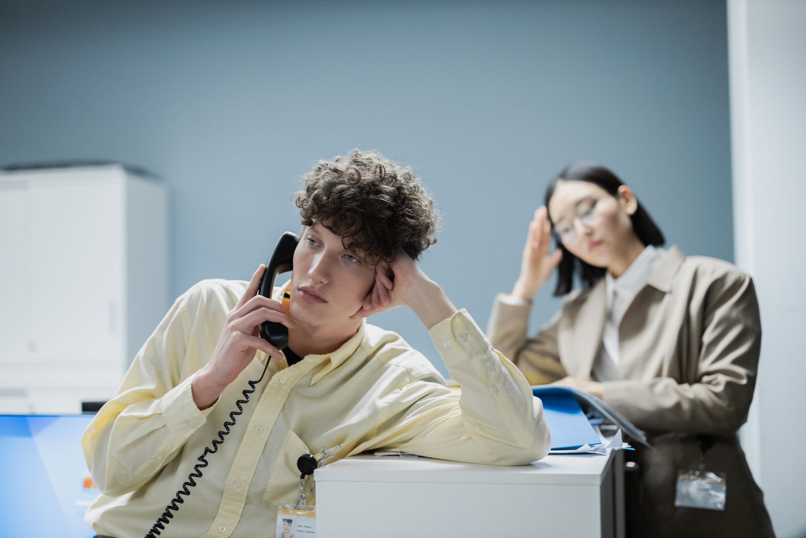 Marketer taking a phone call while an ad performance page is open on his desktop