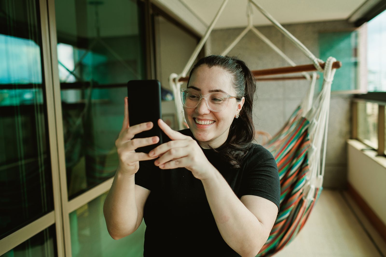 A marketer checking her phone in a bright office