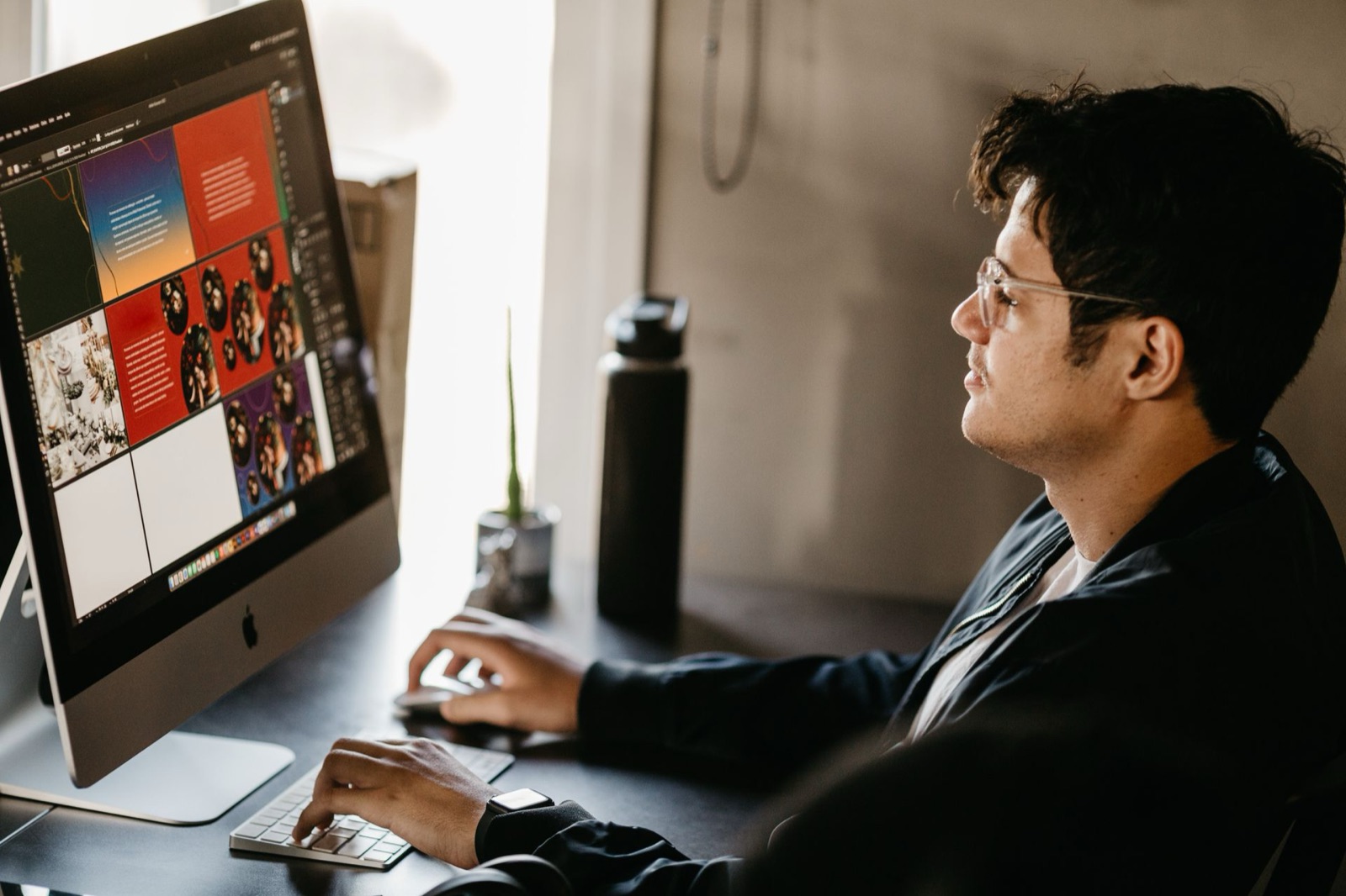 A designer editing a page layout on a desktop computer