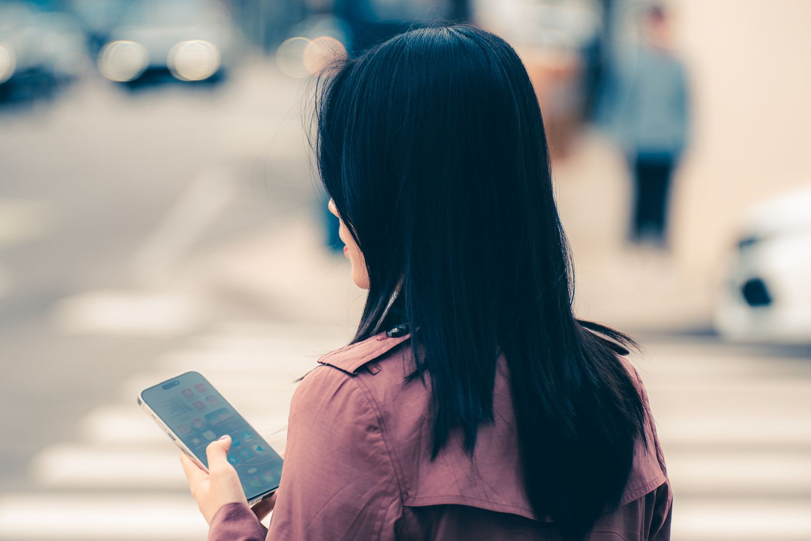Woman using phone city street