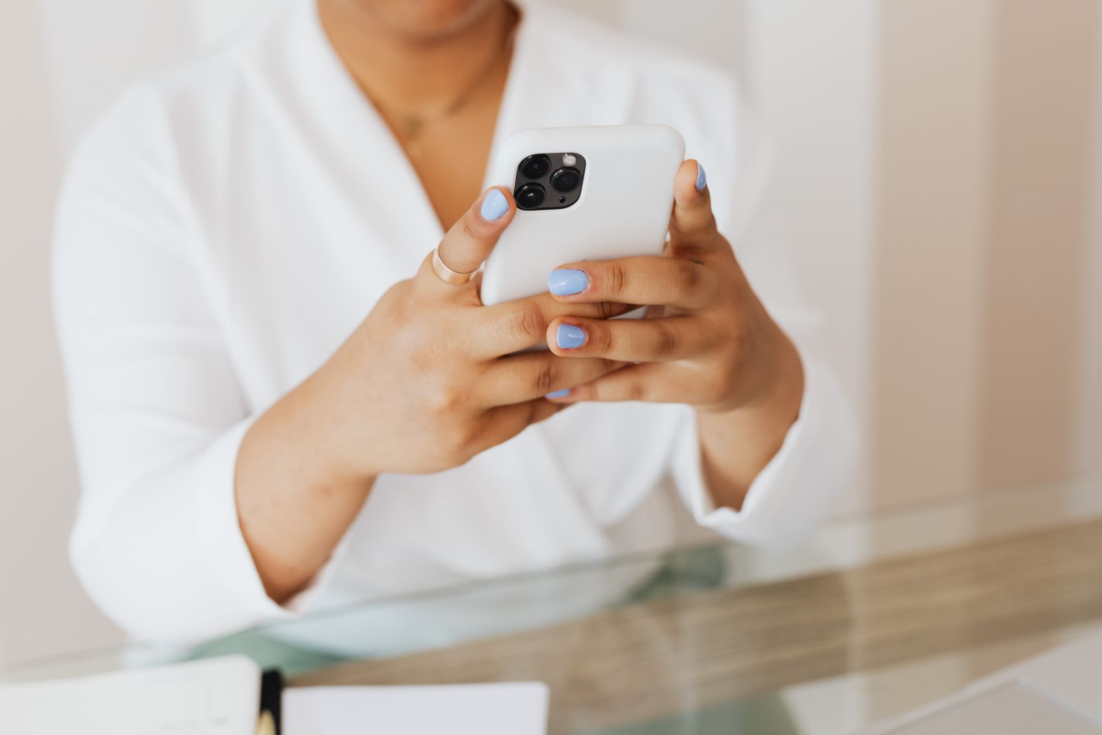 Close-up of a woman using her smartphone with both hands