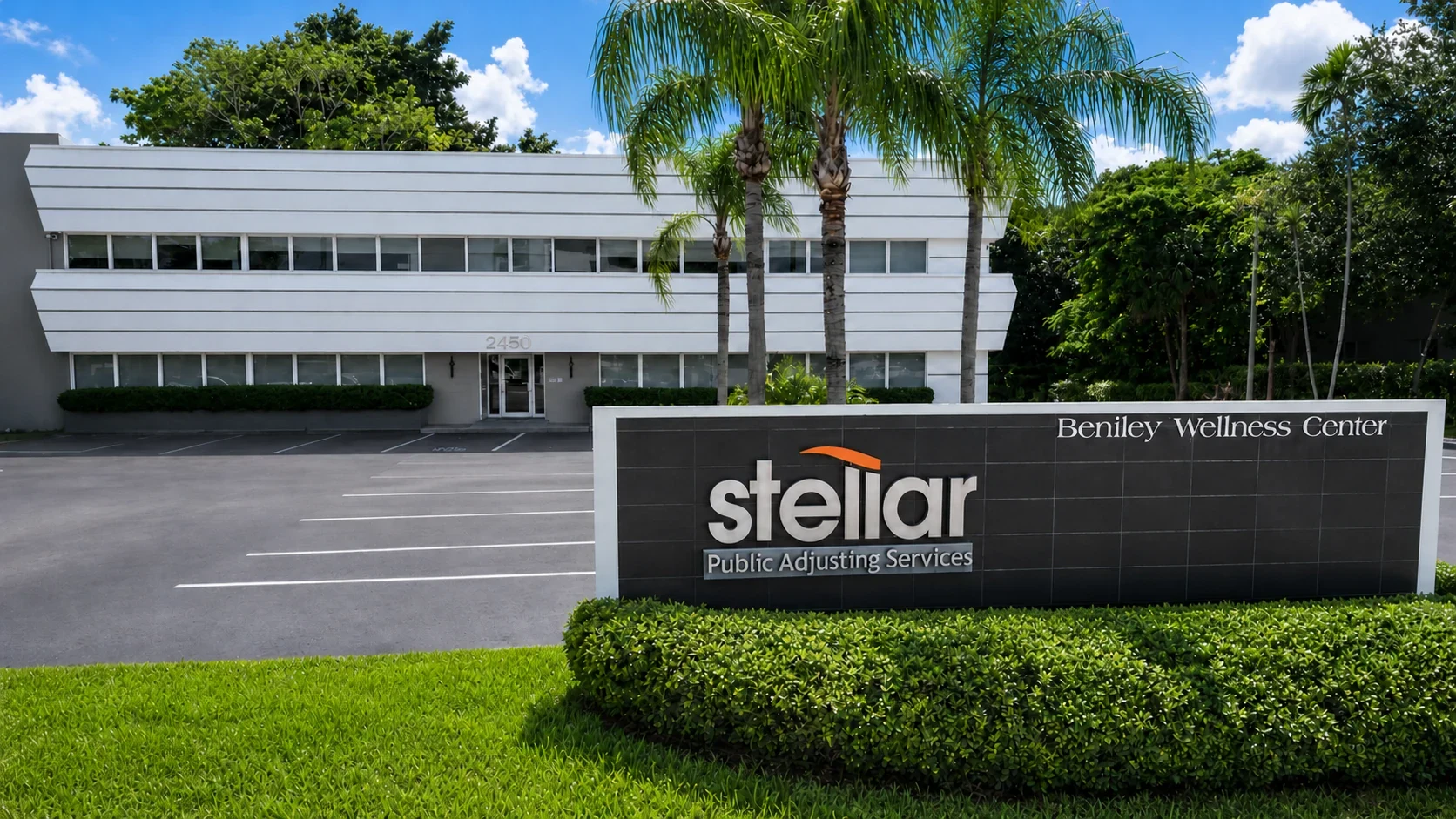 The Stellar Public Adjusting Services sign in front of the firm's Miami office building